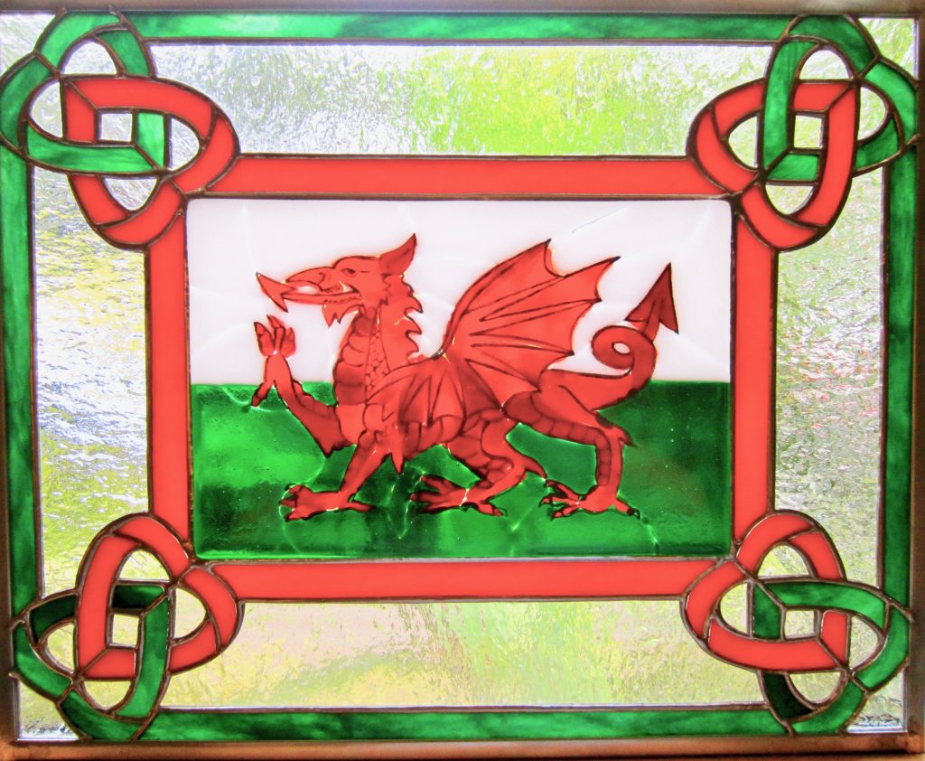 Caron Art Glass stained glass panels anniversary gift Cymru Byw Hir (Long Live Wales) fused glass hand painted details Welsh dragon Welsh flag love spoon design double hearts red green white clear rectangle zinc frame