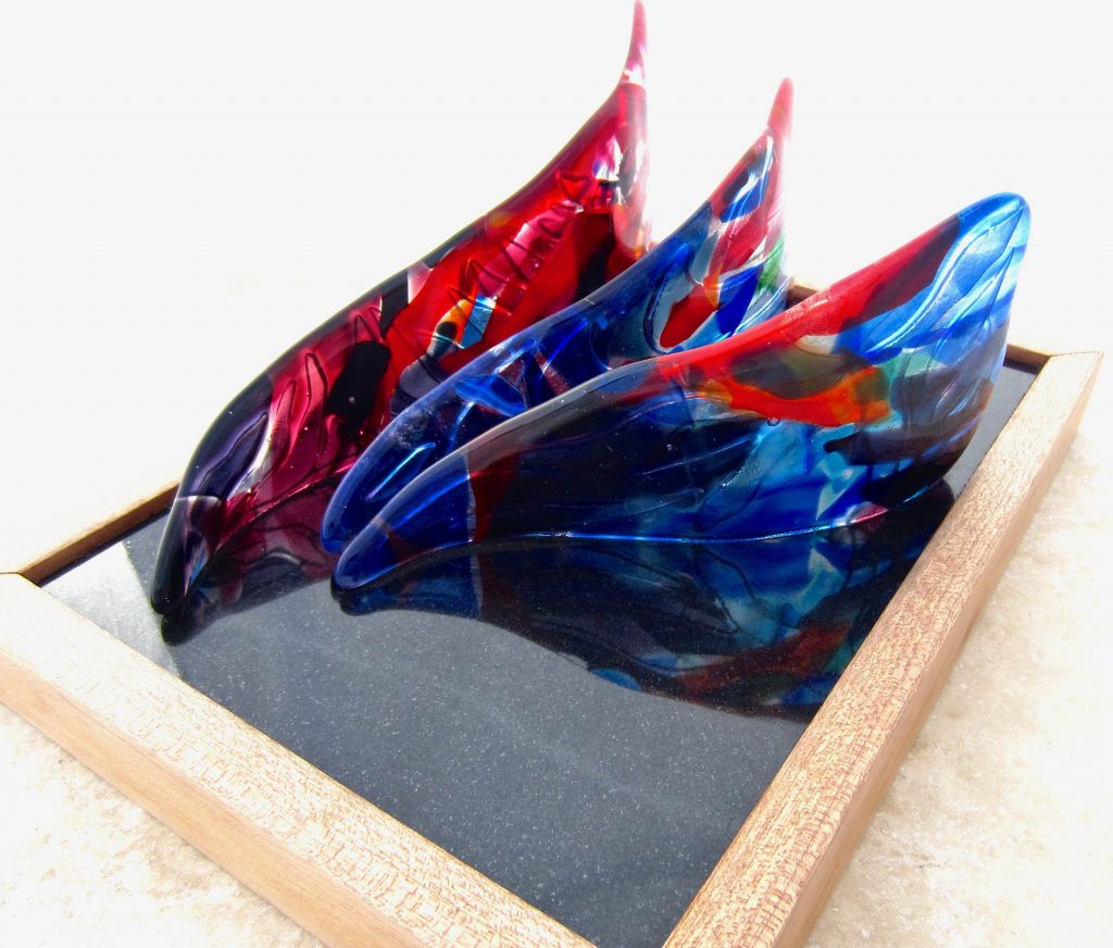 Caron Art Glass fused glass sculpture home decor Hoe A Mau - Room for New Growth hand raked glass kiln carved design red blue black 3 elements triangle granite wood base
