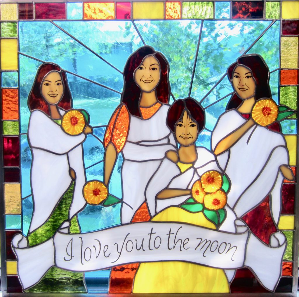 Caron Art Glass Michelle Caron stained glass family portrait I Love You To The Moon fused glass hand painted details three generations women togas sunflowers banner yellow orange green white turquoise amber square zinc frame