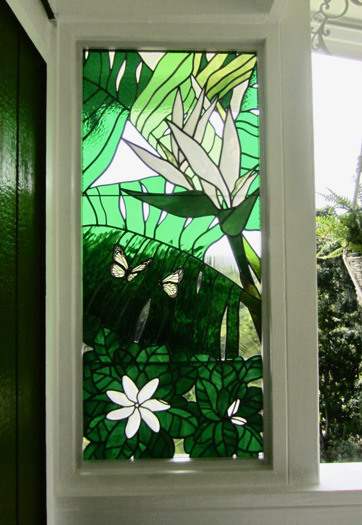 Caron Art Glass architectural art glass lanai window Tiare stained glass fused glass elements hand painted details flowers butterflies tropical plants green white clear rectangle