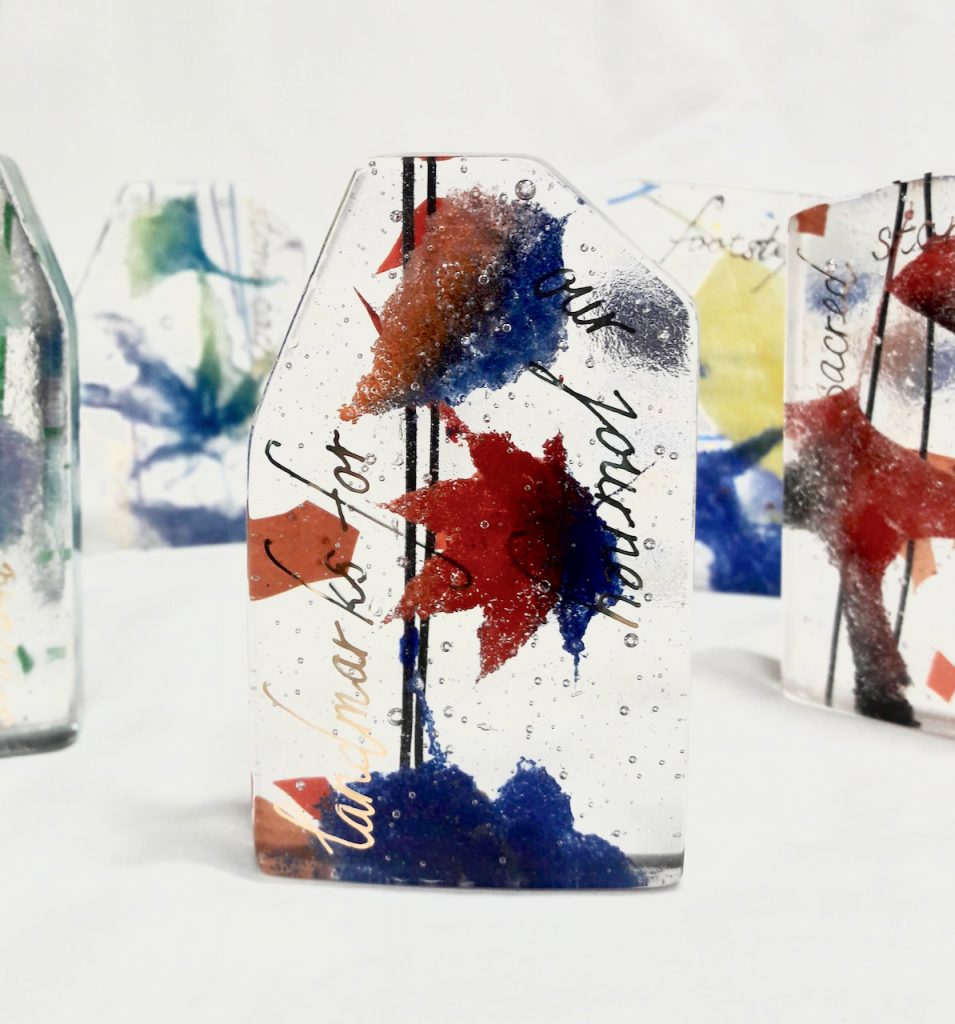 fused glass cairns with fossil vitra red blue enameled leaves gold lettering landmarks for our journey Michelle Caron Caron Art Glass